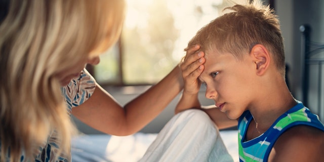 mom monitoring sick child